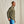 Load image into Gallery viewer, Man wearing a green jacket and blue jeans against a beige background