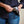 Load image into Gallery viewer, Person holding sunglasses in a dark blue case against a neutral background