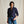 Load image into Gallery viewer, Woman wearing a dark blue patterned shirt and jeans against a beige background