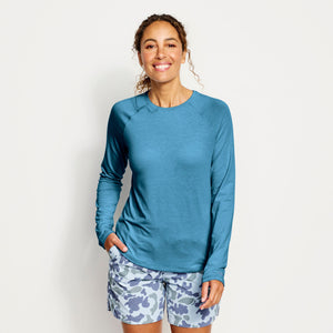 woman smiling to the camera in blue camouflage shorts