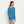 Load image into Gallery viewer, woman modelling blue Orvis sweater and blue camouflage shorts