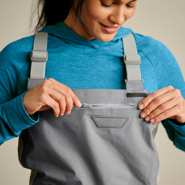 woman adjusting zipper on pocket on wader