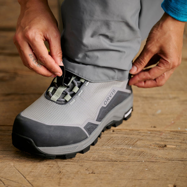 closeup of man adjusting wading boot