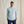 Load image into Gallery viewer, Man wearing a light blue athletic jacket and navy pants against a beige background