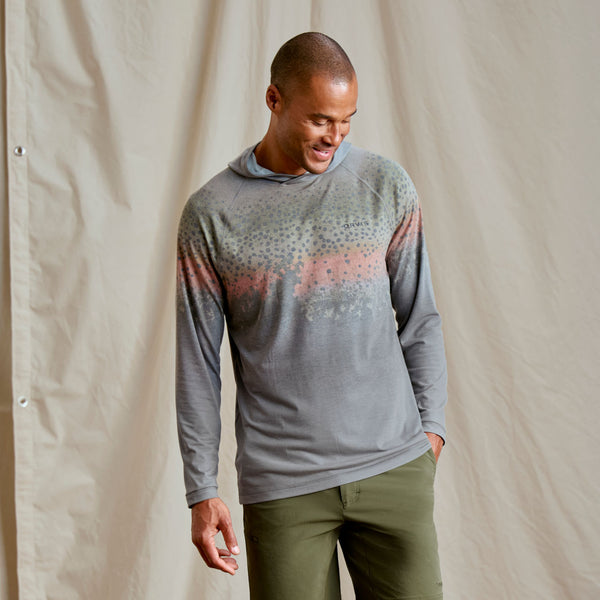 Guy modeling dark green shorts and grey hoodie from Orvis