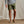 Load image into Gallery viewer, man wearing dark green shorts and flip flips facing camera