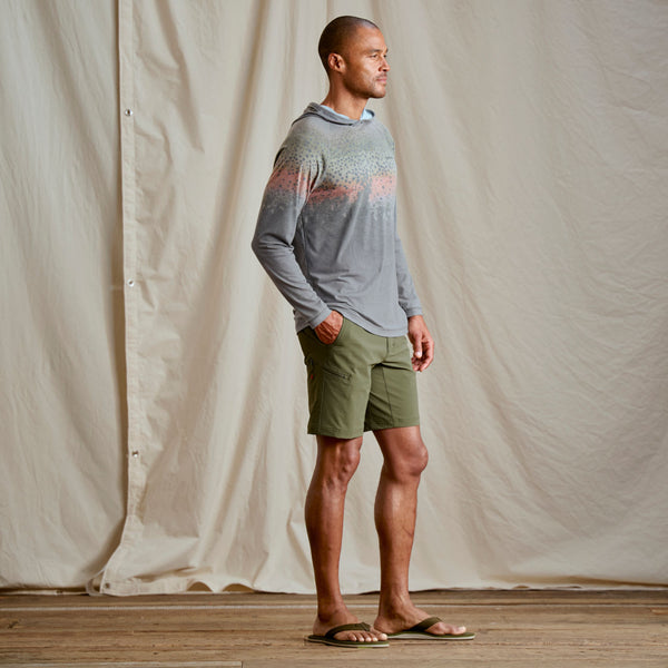 Guy modeling grey hoodie from Orvis with dark green shorts