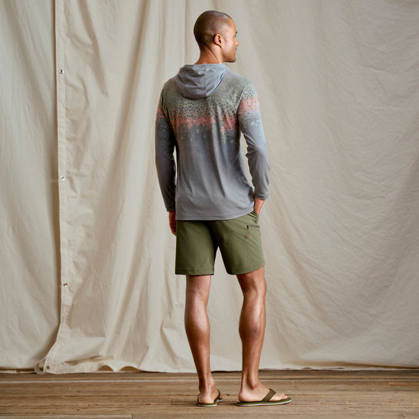 Guy modeling grey hoodie and ark green shorts