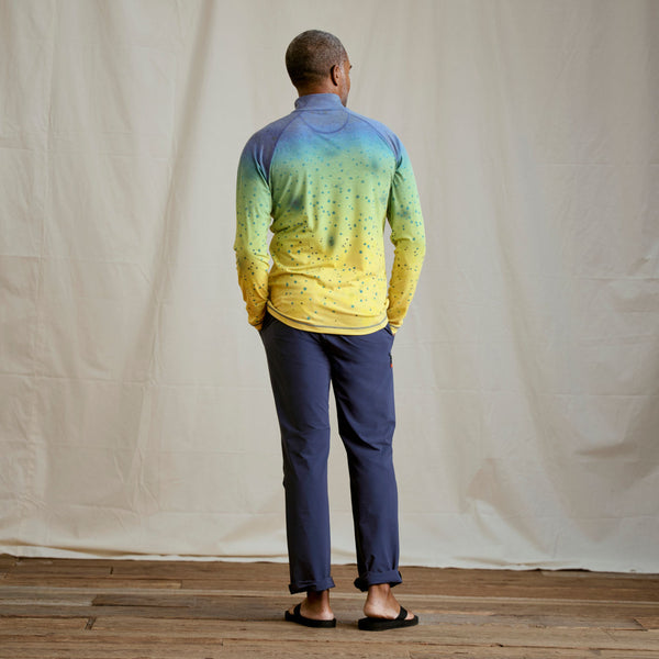 man wearing yellow and blue long-sleeved shirt with back to camera