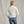 Load image into Gallery viewer, woman facing away from camera in white sweater and jeans