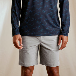man facing camera wearing grey shorts
