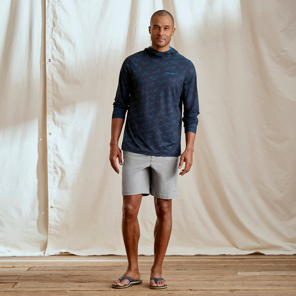 man wearing dark blue hoodie and grey shorts