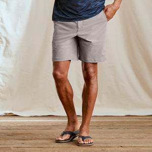 man facing camera wearing grey shorts