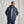 Load image into Gallery viewer, Man wearing a dark grey jacket with a hood against a plain background