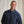 Load image into Gallery viewer, Man wearing a navy blue jacket against a beige background