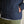Load image into Gallery viewer, Navy blue jacket with a brown leather patch on a beige background