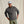 Load image into Gallery viewer, Man wearing a grey quilted jumper and cap against a beige background