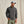 Load image into Gallery viewer, Man wearing a grey quilted pullover, green pants, and a cap against a beige background