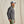 Load image into Gallery viewer, Man wearing a grey quilted jacket and cap against a beige background