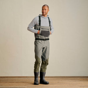 man wearing grey hoodie and waders