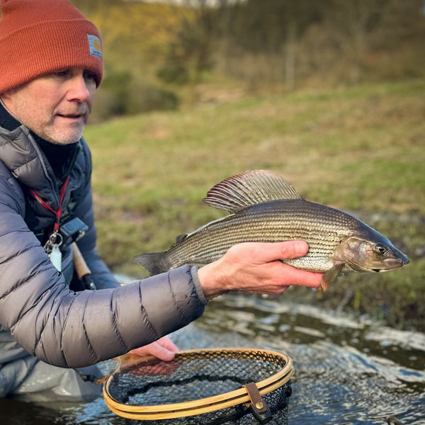 man showing his catch to the camera