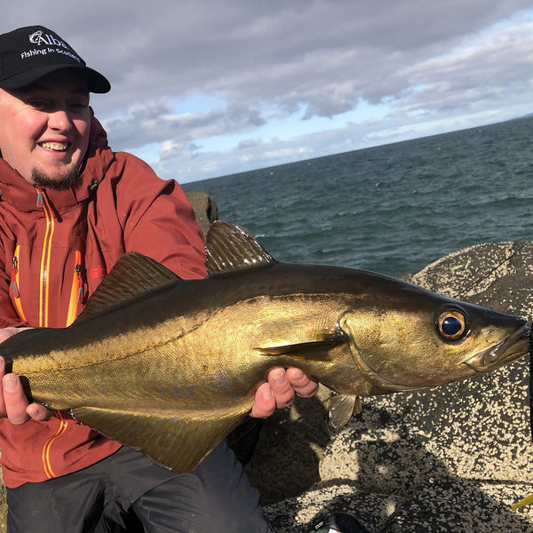 man showing large fish to camera