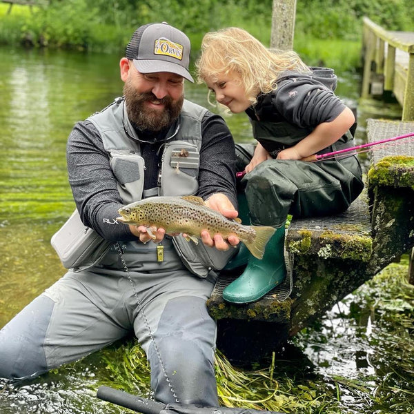man showing child trout