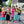 Load image into Gallery viewer, Children holding yellow foam planes in a residential area