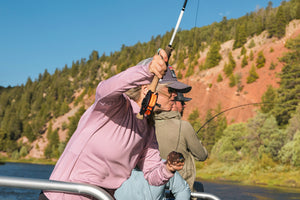 An female angler casts with intensity