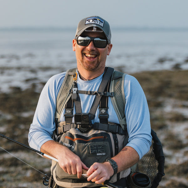fly fisher smiling to the camera