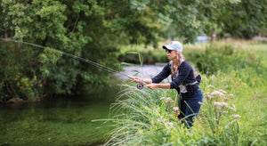 Woman fly-fishing on the River Test.