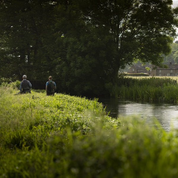 two men on side of river