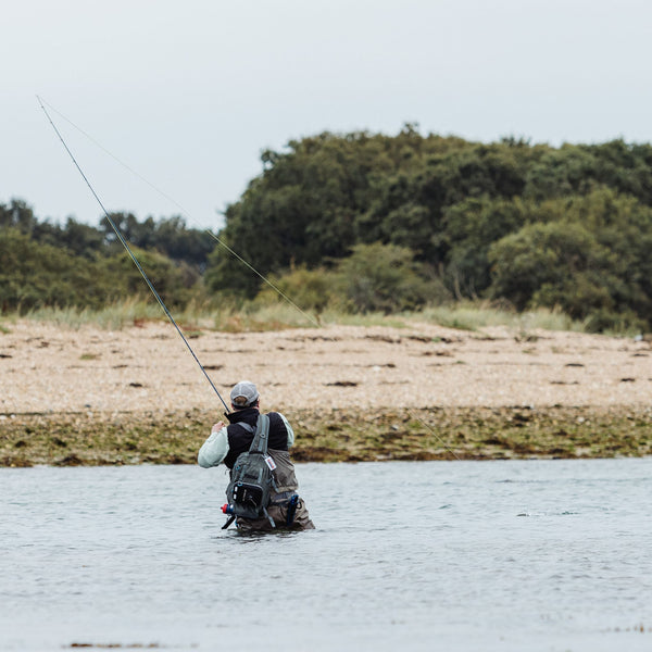 man wading and fly fishing