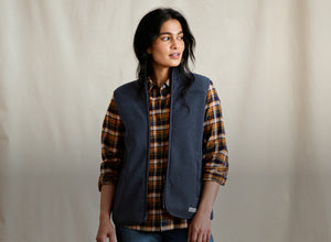 woman wearing checkered shirt and blue vest