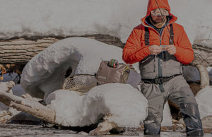 man chaning fly by riverside