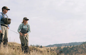 man and woman in wading green in nature