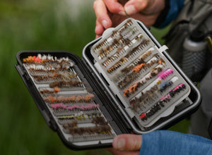 Man showing fly box filled with flies