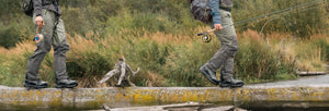 Fishermen balancing on three crossing river