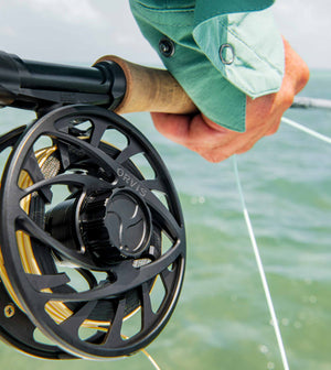 Close up of a Mirage LT reel being held by an angler on the ocean