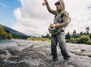 man fly fishing in river