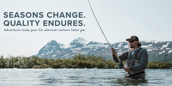 Man fly fishing in a lake with mountains in the background and text about seasons changing and quality enduring.