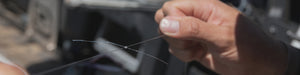 closeup of hands tiying knot on fishing line