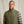 Load image into Gallery viewer, man wearing green vest and brown and orange checkered shirt
