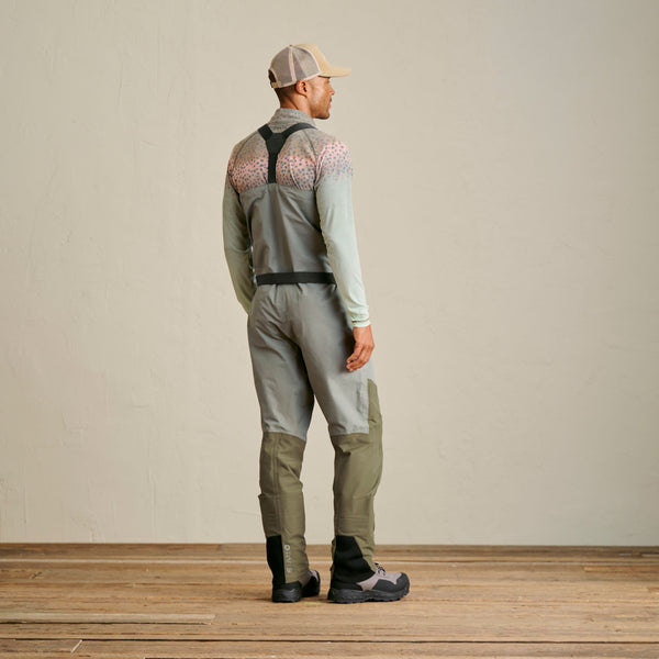 man facing away from the camera wearing wading staff