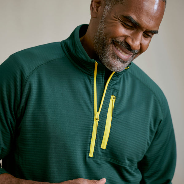 close up of dark green jacket on smiling man