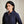 Load image into Gallery viewer, Woman wearing a dark blue patterned shirt against a beige background
