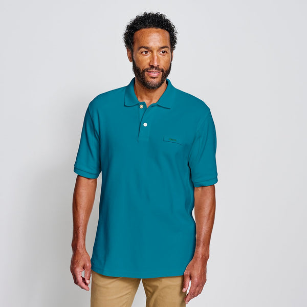 man wearing green shorts-sleeved shirt and beige pants