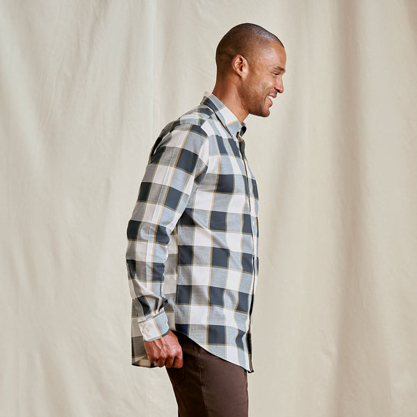 Man wearing a plaid shirt against a plain background
