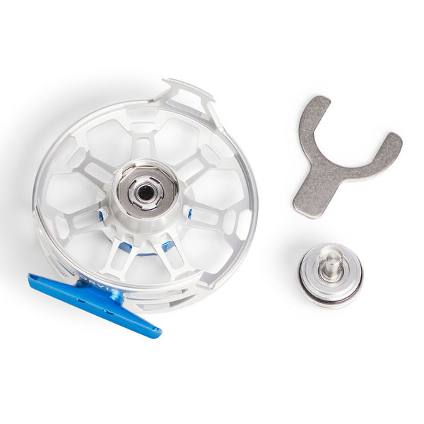 vlue and silver reel in pieces on white background