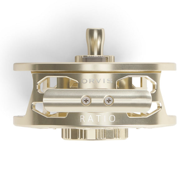 side view of gold Orvis reel on white background